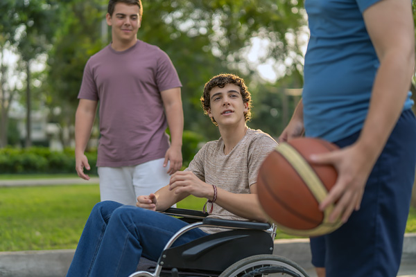 Disabled Person in Wheelchair having fun with friends Disabled Person in Wheelchair having fun with friends