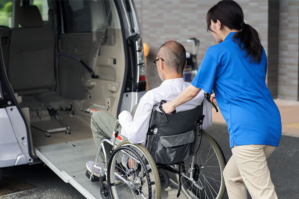 Driver Assisting Wheelchair Client into Vehicle Driver Assisting Wheelchair Client into Vehicle