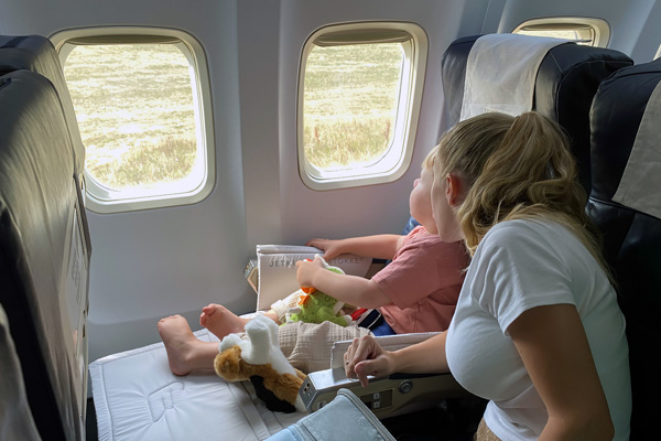 Mother and Child Looking out of Commercial Plane Window