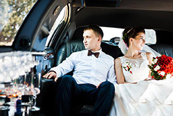 Couple leaving their wedding ceremony in a Phoenix limousine